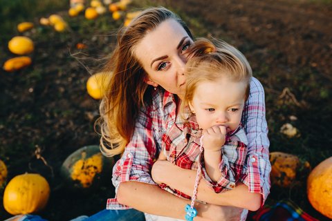 Mom And Daughter In Pumpkin Patch