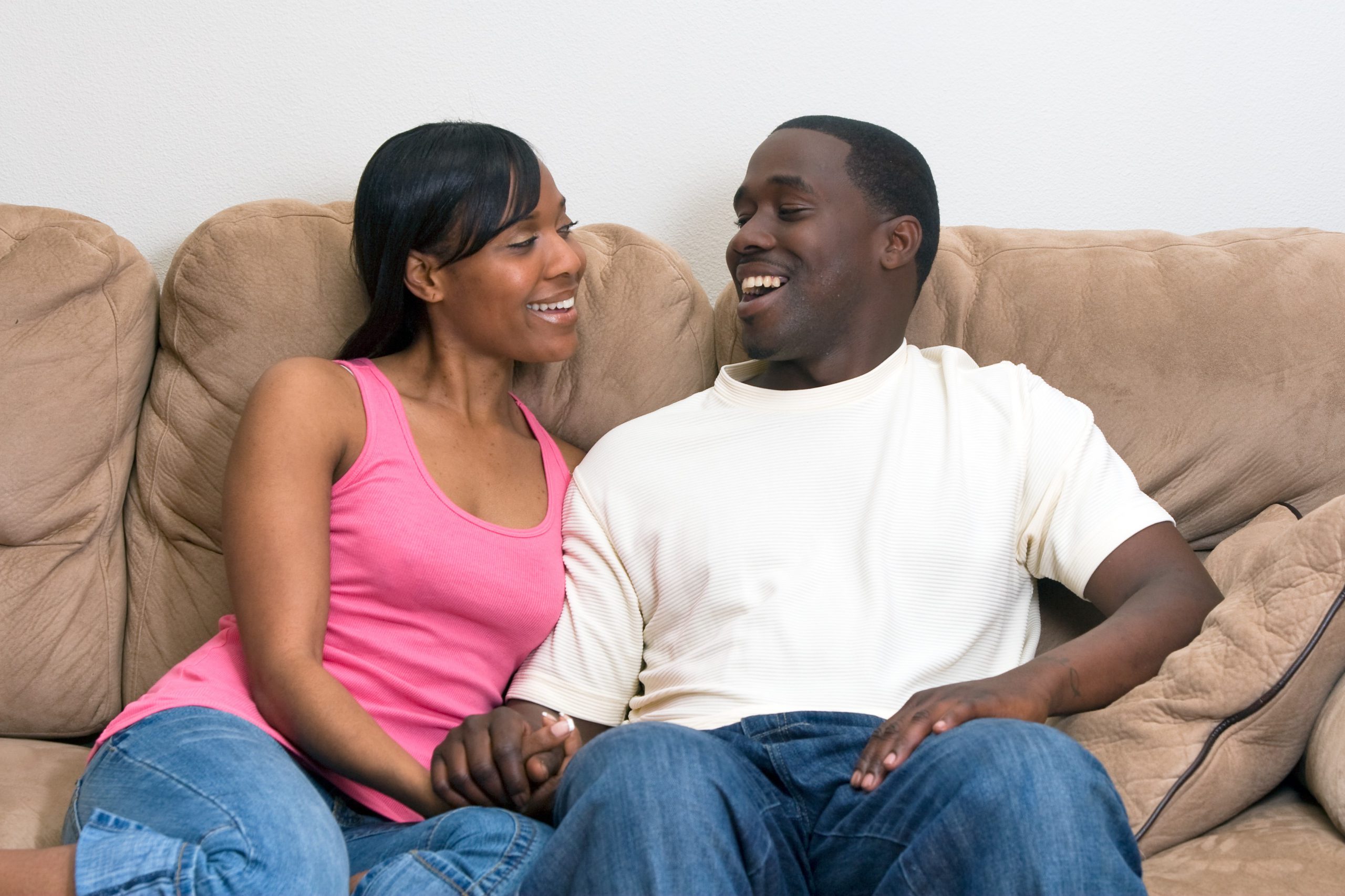 Couple On Couch Laughing